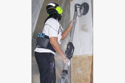 Participant using a vent sander for drywall finishing